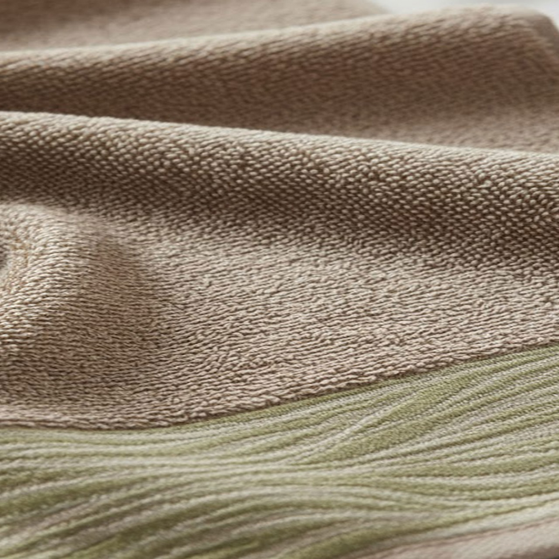 Soft and absorbent cotton towel with a wave-patterned border, perfect for bathroom use.